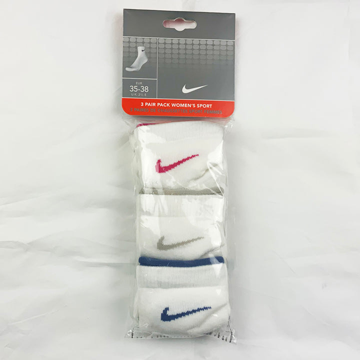 3 Per Pack Y2k Women's Deadstock Vintage Nike Sports Socks in White. Socks has 3 different coloured Nike Swoosh. Pink swoosh, grey swoosh and navy swoosh Colour: White  Brand New with Tags -  SIZE ON TAG: Unisex Adult 2.5 - 5  All our items are of vintage conditions. This means some items may show signs of minor wear. Any major defects will be pictured and stated in the description