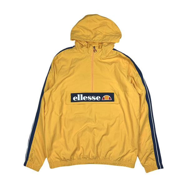 Deadstock ellesse Marnia Oh windbreaker jacket in yellow and navy blue. Ellesse branding and spellout to front. 1/2 zip closure. Zip pocket to front under logo. Elastic waist. - Colour: Yellow Brand New with Tags - Size on Tag: Large Measurements: Pit to Pit: 24.5 Inches Length: 29.5 Inches