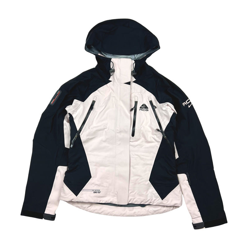 2005 Women's Deadstock Vintage Nike ACG jacket in black and light pink. Nike ACG logo to chest. Two way zip closure to jacket. Zip pocket to chest. Zip pockets to front at sides. Zip pocket to sleeve. Adjustable cord to hood. Inner media compartment. Gore-Tex technology a waterproof, breathable fabric. Recco technology