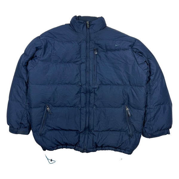 Y2K Vintage Nike swoosh puffer jacket in navy blue. Nike swoosh branding to chest. Pockets to front. Zip closure to jacket. Down filled. Adjustable cord to waist. - Colour: Black & Red Condition: Good - some minor wear to jacket as seen in images - Size on Tag: Medium Measurements: Pit to Pit: 27 Inches Length: 30 Inches