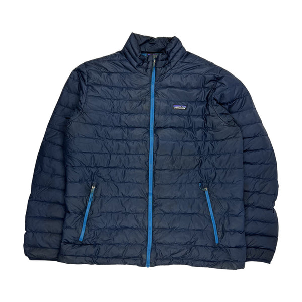 Y2K Vintage Patagonia puffer jacket in navy blue. Patagonia branding to chest. Zip pockets to front. Zip closure to jacket. Lightweight packable jacket. Down filled. - Colour: Navy Blue Condition: Good - marks on jackets as seen in images - Size on Tag: XL Measurements: Pit to Pit: 25 Inches Length: 29 Inches