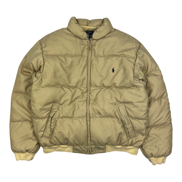 Y2K Vintage Ralph Lauren puffer jacket in beige. Embroidered Ralph Lauren branding. Pockets to front. Zip closure to jacket. Inner pocket. Padded. Elastic waist. Down Filled. - Colour: Beige Condition: Good - Size on Tag: XL (recommended size: small/medium) Measurements: Pit to Pit: 21 Inches Length: 24 Inches